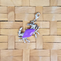 Crab jewelry charm with purple enameled shell and lobster claw clasp